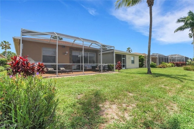 8644 Ibis Cove Cir, Naples, FL 34119 - back of house featuring a lawn, a lanai, and stucco siding