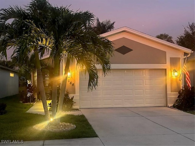 8644 Ibis Cove Cir, Naples, FL 34119 - view of front of property with driveway, a garage, and stucco siding