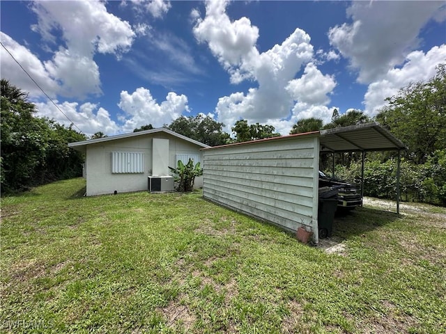 16940 Tarpon Way N, Fort Myers, FL 33917 - view of side of home featuring a yard and a central AC unit