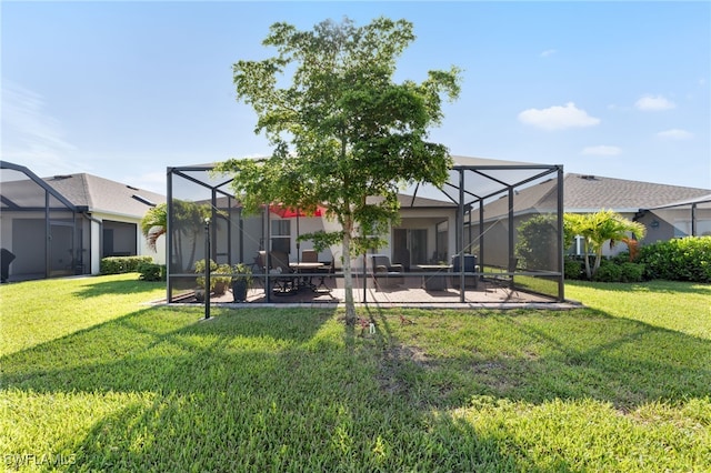 2245 Pigeon Plum Way N, Fort Myers, FL 33917 - rear view of property with a patio area, a yard, and glass enclosure