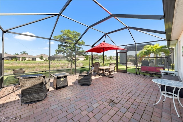 2245 Pigeon Plum Way N, Fort Myers, FL 33917 - view of patio featuring a lanai, a fire pit, and outdoor dining space