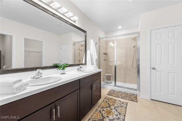 2245 Pigeon Plum Way N, Fort Myers, FL 33917 - full bathroom with a stall shower, double vanity, tile patterned flooring, and a walk in closet