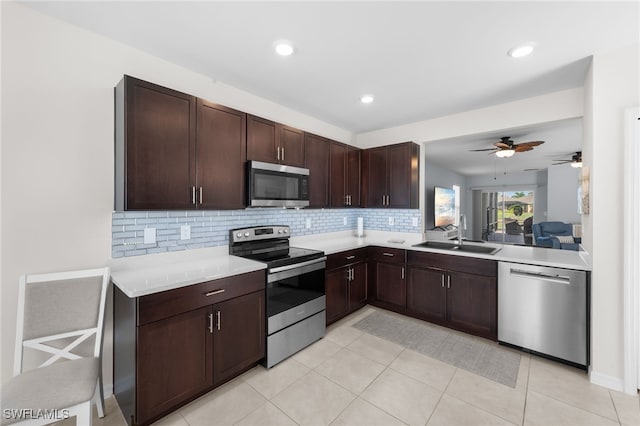 2245 Pigeon Plum Way N, Fort Myers, FL 33917 - kitchen featuring appliances with stainless steel finishes, backsplash, light countertops, dark brown cabinetry, and ceiling fan