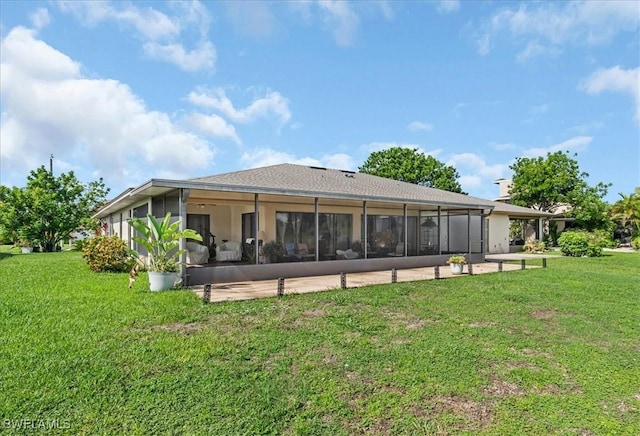 20013 Petrucka Cir N, Lehigh Acres, FL 33936 - back of property with a sunroom and a lawn