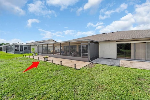 20013 Petrucka Cir N, Lehigh Acres, FL 33936 - rear view of property featuring a sunroom, a lawn, and a patio