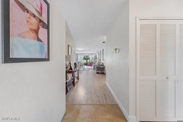 20013 Petrucka Cir N, Lehigh Acres, FL 33936 - hallway featuring tile patterned floors and baseboards