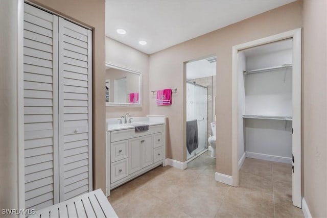 20013 Petrucka Cir N, Lehigh Acres, FL 33936 - bathroom with a shower stall, vanity, tile patterned floors, a spacious closet, and recessed lighting