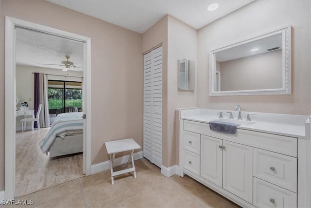 20013 Petrucka Cir N, Lehigh Acres, FL 33936 - ensuite bathroom featuring vanity, a ceiling fan, and tile patterned floors