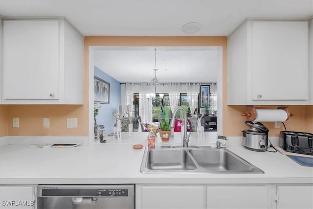 20013 Petrucka Cir N, Lehigh Acres, FL 33936 - kitchen with dishwasher, white cabinets, light countertops, and a chandelier