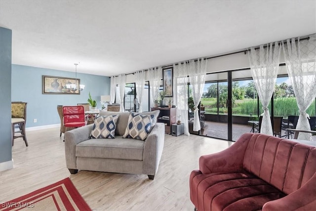20013 Petrucka Cir N, Lehigh Acres, FL 33936 - living room with a chandelier and light wood-style floors
