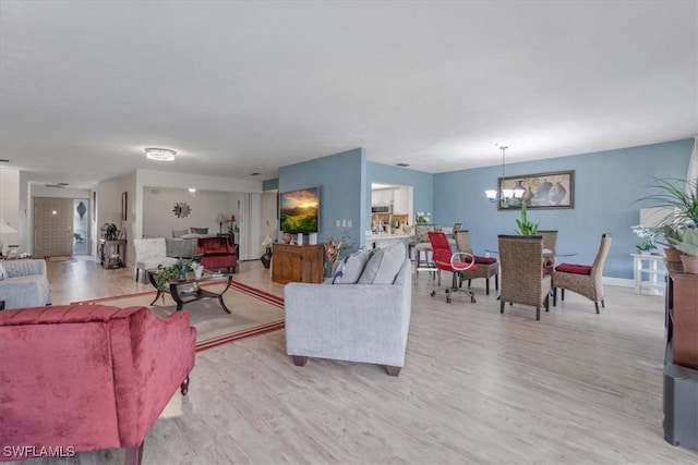 20013 Petrucka Cir N, Lehigh Acres, FL 33936 - living area featuring a chandelier and light wood-type flooring