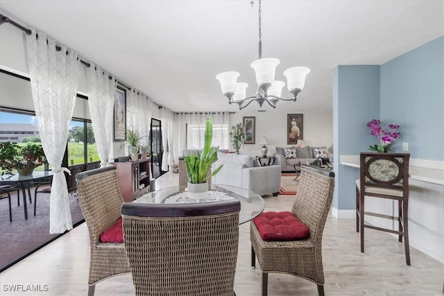 20013 Petrucka Cir N, Lehigh Acres, FL 33936 - dining space featuring a chandelier and light wood-style flooring