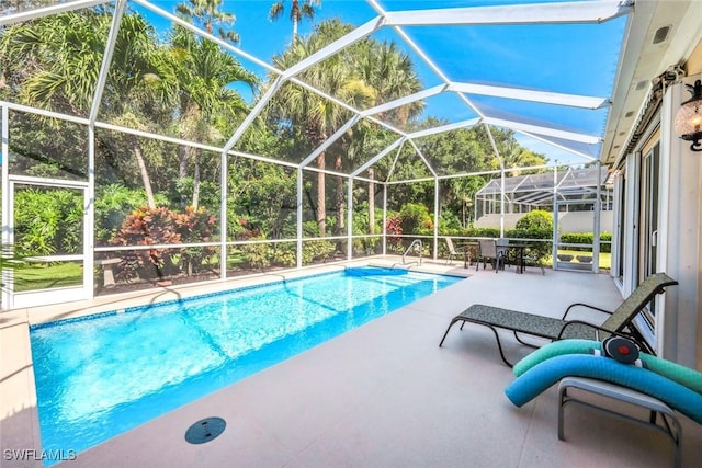 2799 Jude Island Way, Naples, FL 34119 - outdoor pool featuring a patio area and glass enclosure
