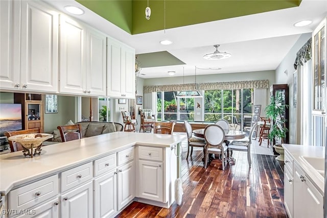 2799 Jude Island Way, Naples, FL 34119 - kitchen with dark wood finished floors, white cabinetry, pendant lighting, recessed lighting, and light countertops