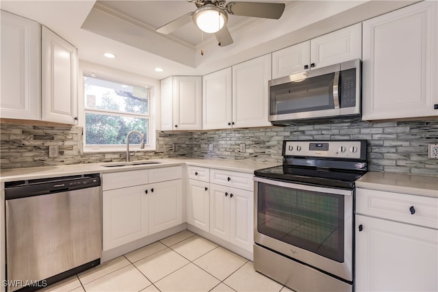 217 Yorkshire Ct Unit 2, Naples, FL 34112 - kitchen with stainless steel appliances, a raised ceiling, light tile patterned floors, white cabinets, and recessed lighting