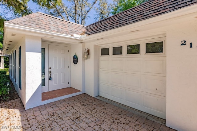 217 Yorkshire Ct Unit 2, Naples, FL 34112 - entrance to property featuring stucco siding, roof with shingles, and an attached garage