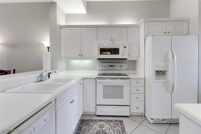 401 Bayfront Pl Unit 3502, Naples, FL 34102 - kitchen featuring white appliances, light tile patterned floors, light countertops, and white cabinetry