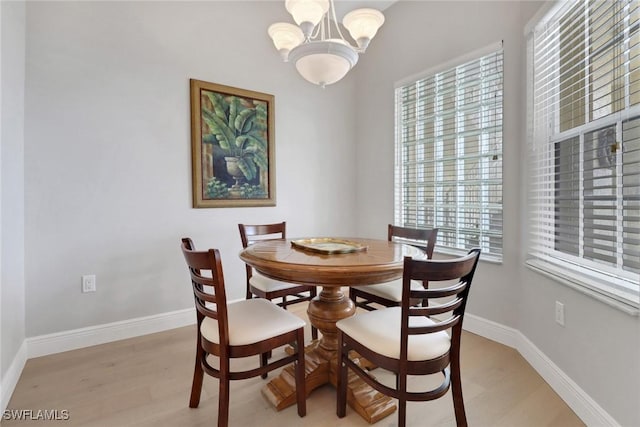 401 Bayfront Pl Unit 3502, Naples, FL 34102 - dining space featuring a chandelier and light wood finished floors