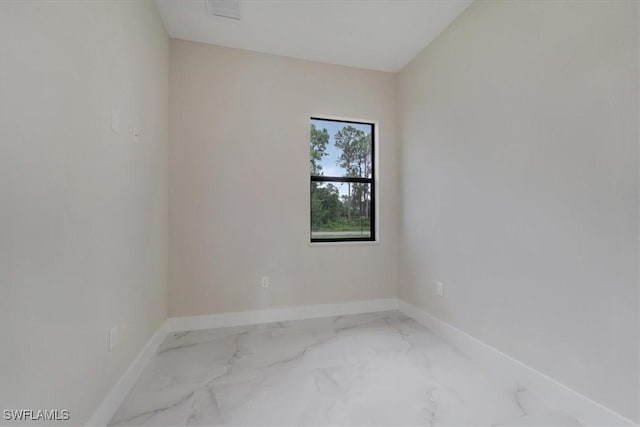 915 Anthony St E, Lehigh Acres, FL 33974 - spare room with baseboards and marble finish flooring