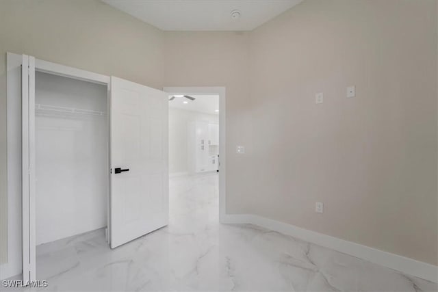 915 Anthony St E, Lehigh Acres, FL 33974 - unfurnished bedroom with light marble finish floors and a closet