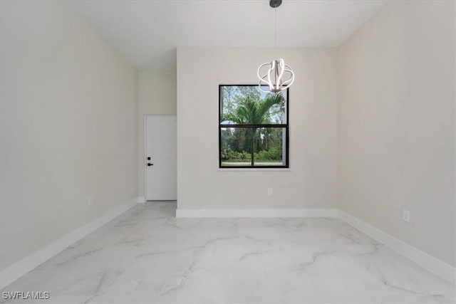 915 Anthony St E, Lehigh Acres, FL 33974 - empty room featuring a chandelier and marble finish flooring