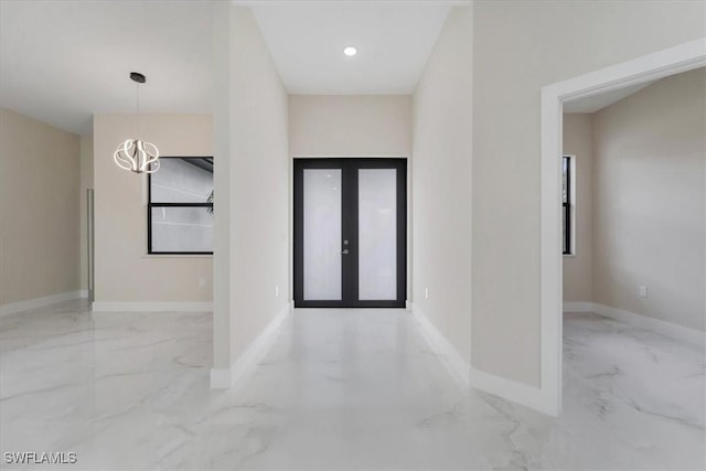 915 Anthony St E, Lehigh Acres, FL 33974 - entryway with marble tiled floors and a chandelier