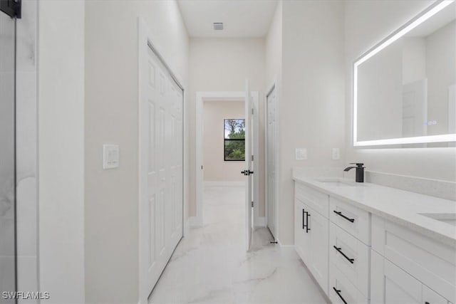915 Anthony St E, Lehigh Acres, FL 33974 - bathroom featuring marble look tile flooring and double vanity