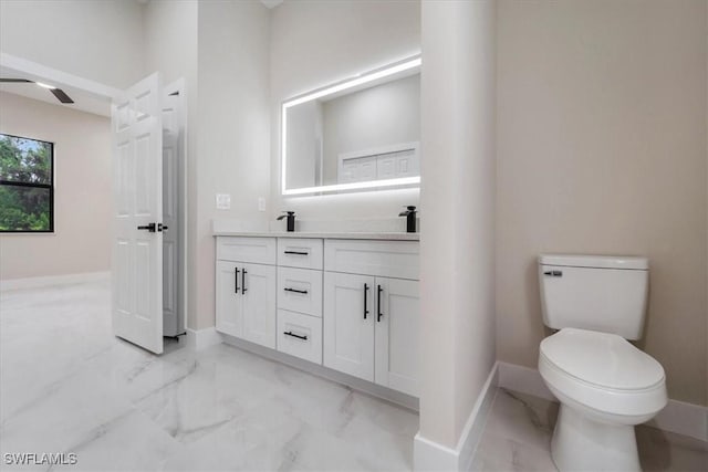 915 Anthony St E, Lehigh Acres, FL 33974 - bathroom with marble look tile flooring, double vanity, and ceiling fan