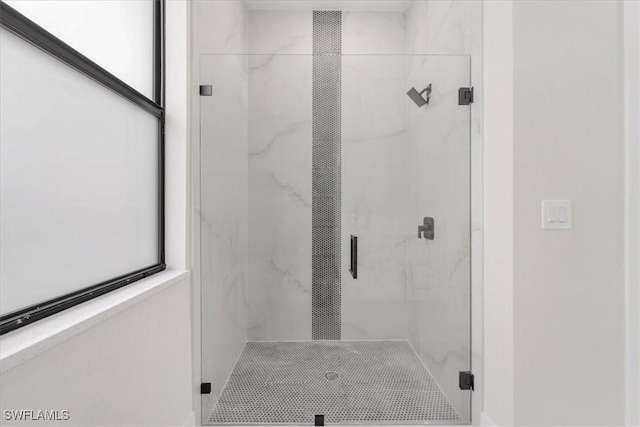 915 Anthony St E, Lehigh Acres, FL 33974 - bathroom featuring a marble finish shower