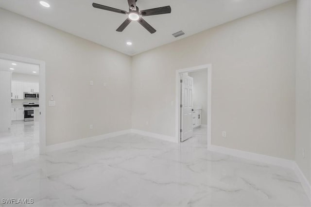 915 Anthony St E, Lehigh Acres, FL 33974 - unfurnished room featuring light marble finish floors, ceiling fan, and recessed lighting