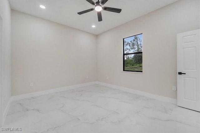 915 Anthony St E, Lehigh Acres, FL 33974 - spare room with marble finish floors, a ceiling fan, and recessed lighting