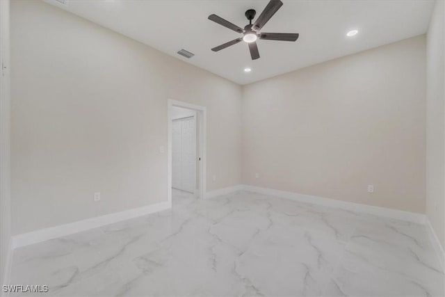 915 Anthony St E, Lehigh Acres, FL 33974 - empty room with ceiling fan, marble look tile flooring, and recessed lighting