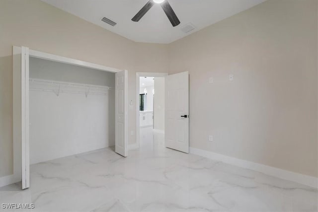 915 Anthony St E, Lehigh Acres, FL 33974 - unfurnished bedroom featuring marble finish flooring, a closet, and ceiling fan