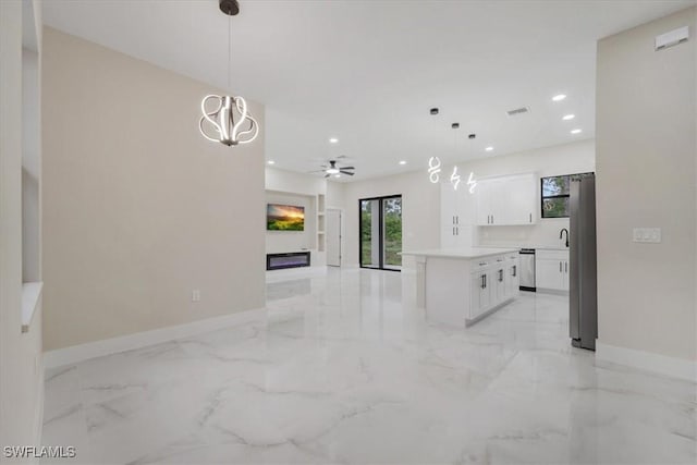 915 Anthony St E, Lehigh Acres, FL 33974 - kitchen with recessed lighting, stainless steel dishwasher, light marble finish floors, fridge, and white cabinetry