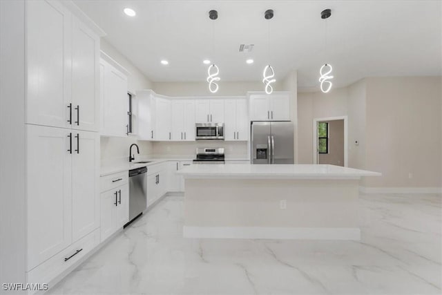 915 Anthony St E, Lehigh Acres, FL 33974 - kitchen with appliances with stainless steel finishes, light marble finish flooring, white cabinets, and recessed lighting