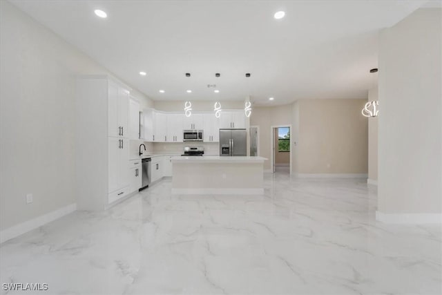 915 Anthony St E, Lehigh Acres, FL 33974 - kitchen with stainless steel appliances, recessed lighting, a center island, white cabinets, and light countertops