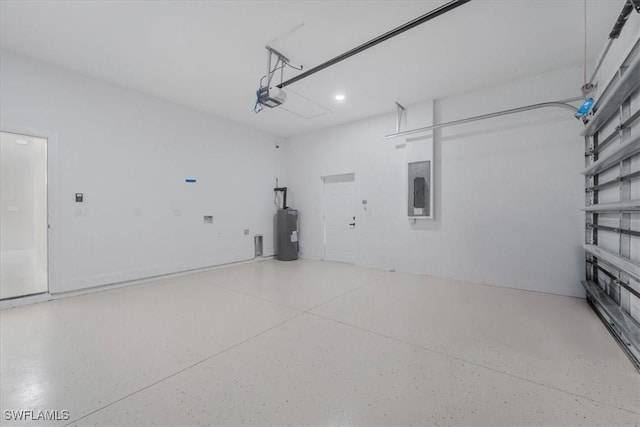 915 Anthony St E, Lehigh Acres, FL 33974 - garage featuring a garage door opener, electric panel, electric water heater, and recessed lighting