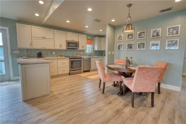 6008 Cypress Ln, Bonita Springs, FL 34134 - dining room with light wood finished floors and recessed lighting