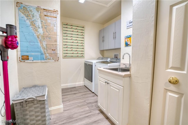 6008 Cypress Ln, Bonita Springs, FL 34134 - laundry area featuring cabinet space, washing machine and dryer, and light wood-type flooring
