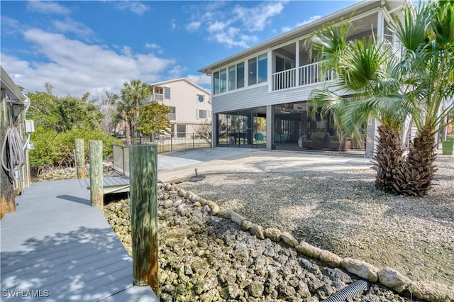 6008 Cypress Ln, Bonita Springs, FL 34134 - view of yard with a sunroom, a carport, a patio area, and gravel driveway