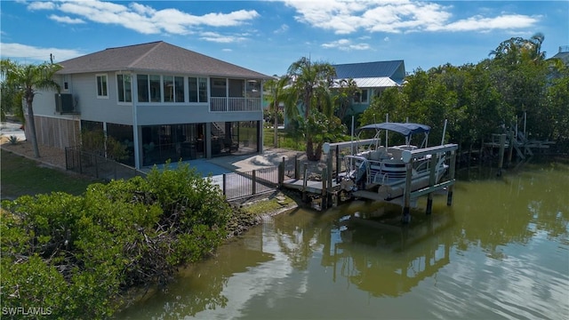6008 Cypress Ln, Bonita Springs, FL 34134 - dock area with boat lift, a water view, and a patio
