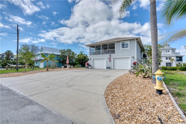 6008 Cypress Ln, Bonita Springs, FL 34134 - coastal home with concrete driveway, an attached garage, and a residential view