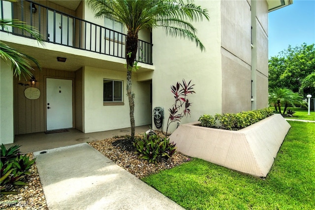 2079 Barkeley Ln Unit 6, Fort Myers, FL 33907 - doorway to property featuring stucco siding and a balcony