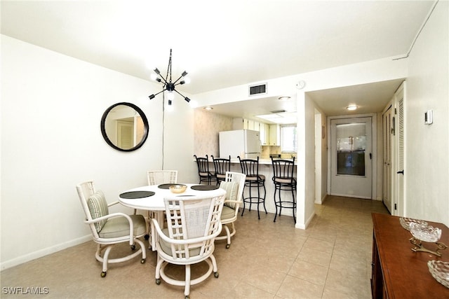 2079 Barkeley Ln Unit 6, Fort Myers, FL 33907 - dining space featuring light tile patterned floors and a chandelier