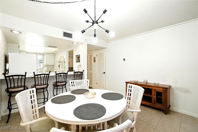 2079 Barkeley Ln Unit 6, Fort Myers, FL 33907 - dining area with a chandelier and light tile patterned floors