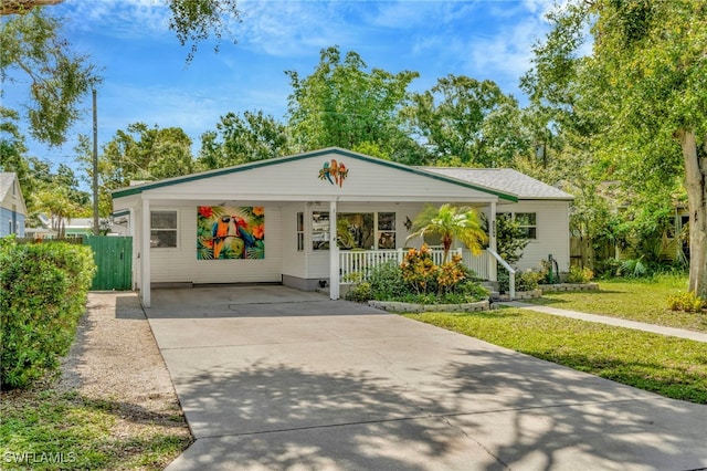 1308 Hull St S, Gulfport, FL 33707 - view of front of property with an attached carport, concrete driveway, and a porch