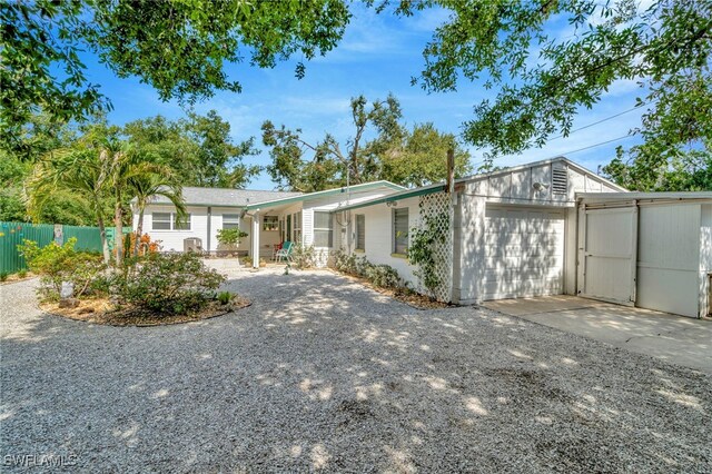 1308 Hull St S, Gulfport, FL 33707 - view of front facade featuring concrete driveway and a garage