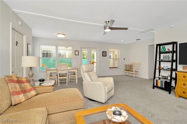 1308 Hull St S, Gulfport, FL 33707 - living room with a ceiling fan and light colored carpet