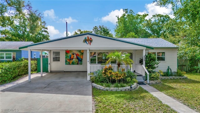 1308 Hull St S, Gulfport, FL 33707 - view of front of home featuring concrete driveway, a carport, and covered porch