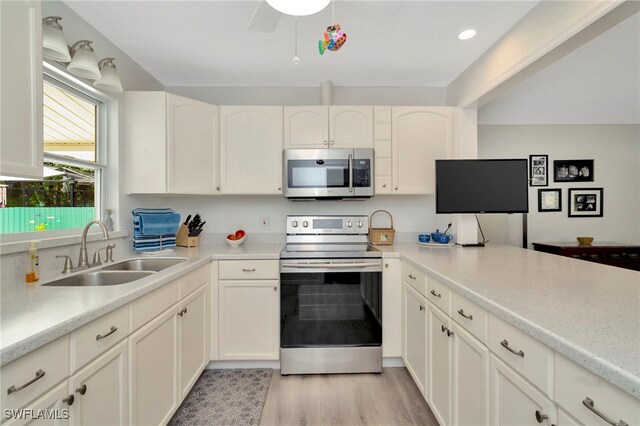 1308 Hull St S, Gulfport, FL 33707 - kitchen with stainless steel appliances, light countertops, and white cabinets